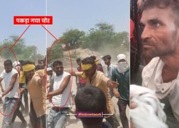 लोग चोर को पकड़ कर ले जाते हुए